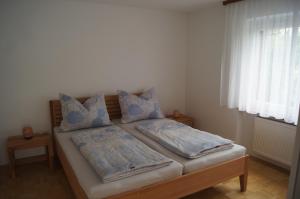 a bedroom with a bed with blue pillows on it at Ferienwohnung Beate in Höchst