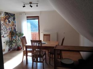 a dining room with a wooden table and chairs at Ferienhaus Hilde in Steinwiesen