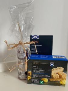 a box and a glass vase with some bread at Self-contained luxurious feel apartment in Dunfermline