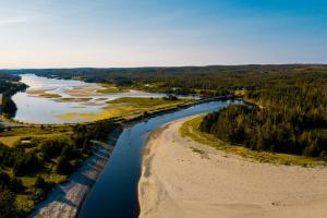 an aerial view of a river next to a beach at Lonely Rock Seaside Bungalows in Larrys River