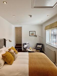 een slaapkamer met een groot bed en een stoel bij Upstairs at 33 - Self check in boutique accommodation in Worcester Centre in Worcester