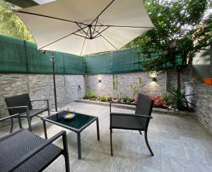 eine Terrasse mit einem Tisch und einem Sonnenschirm in der Unterkunft Mimma’s house Monteverde in Rom