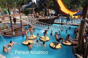 a group of people in the water at a water park at Las Mozitas 1 in Barra del Chuy