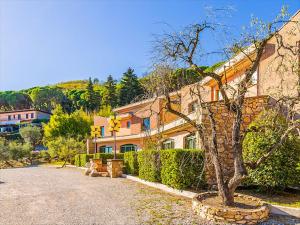 a building with a tree in front of a street at Albergo Santa Barbara in Montecatini Terme