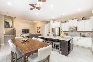 a kitchen and dining room with a wooden table and chairs at Villa Princess townhouse in Scottsdale