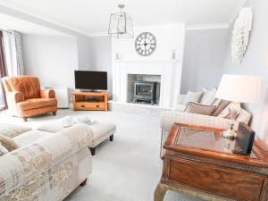a living room with two couches and a tv at 12 Claremont Falls in Looe