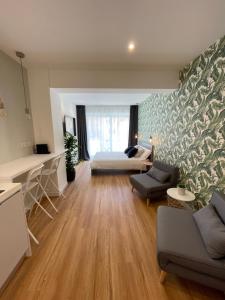 a living room with a couch and a bed at Vento Suites in Cagliari