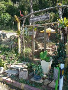a small garden with a sign and some plants at Conjugado Aconchegante em Teresópolis in Teresópolis