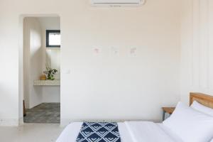 1 Schlafzimmer mit 2 Betten und einem Spiegel in der Unterkunft Contemporary Artisanal Studio Apartment in Ubud in Ubud