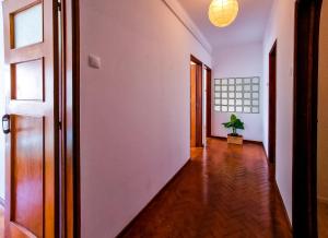 a hallway with white walls and a potted plant at FLH Loulé Balcony Spacious Apartment in Loulé +7 photos