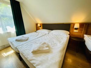 Postel nebo postele na pokoji v ubytování Villa Pinus Slovenský raj - Hotel Čingov dependance