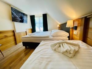 Säng eller sängar i ett rum på Villa Pinus Slovenský raj - Hotel Čingov dependance