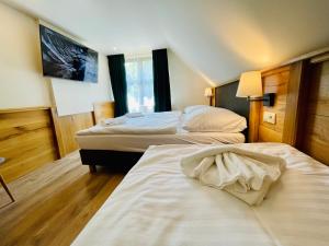 Postel nebo postele na pokoji v ubytování Villa Pinus Slovenský raj - Hotel Čingov dependance