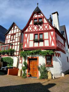 a red and white building with at Ferienwohnung Julia in Sankt Aldegund
