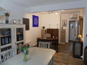 a living room with a table and a piano at Toki Eder chez Marisol, piscine chauffée, décoration soignée et océan à 15 minutes entre Bayonne et Hossegor in Saint-Martin-de-Seignanx