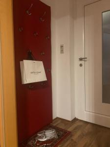 a room with a red door with a white bag on it at Schilcherland-Apartment in Stainz