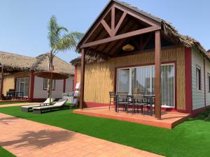 a house with a patio with a table and chairs at La Marina Resort in La Marina