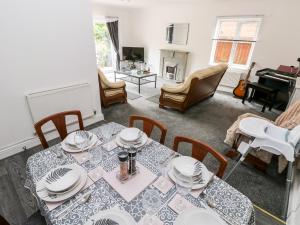 a dining room with a table and chairs at 23 Charles Thomas Avenue in Pembroke Dock