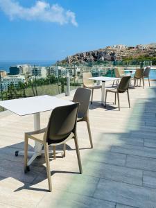 a group of tables and chairs on a roof at Hotel VIU57 in Mellieħa