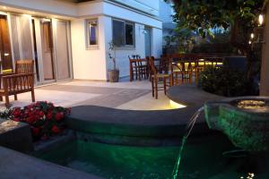 a patio with a fountain and tables and chairs at Philoxenia Hotel & Studios in Rhodes Town