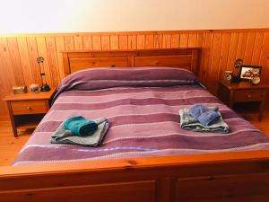 a bed with two towels on top of it at Ferienhaus Anders in Terjärv