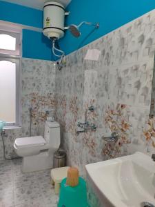 a bathroom with a sink and a toilet at The Lachung Inn in Lachung