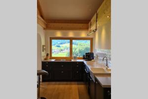 a kitchen with a large sink and a window at Ferienwohnung Otto in Ruhpolding +1 photo