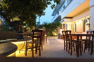 a row of tables and chairs on a patio at Philoxenia Hotel & Studios in Rhodes Town