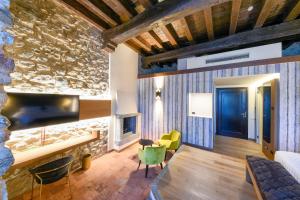 a living room with a stone wall and a fireplace at Relais & Spa Castello di Casiglio in Erba