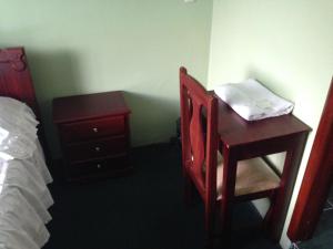 Postel nebo postele na pokoji v ubytování Hostal Los Lirios