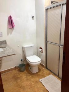 a bathroom with a toilet and a sink at Pousada Casa do Fabio - Bikers point in Águas da Prata