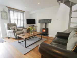 a living room with a couch and a coffee table at Cobble Cottage in Kendal