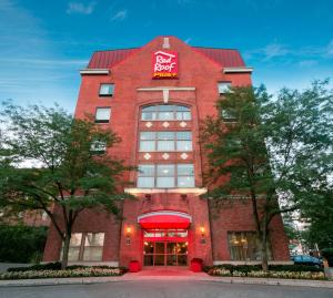 un edificio de ladrillo rojo con un cartel. en Red Roof Inn PLUS+ Columbus Downtown - Convention Center, en Columbus