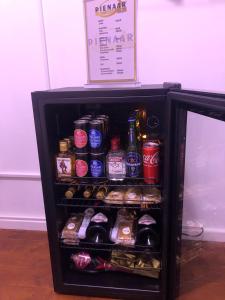 a small refrigerator filled with lots of drinks at St Pete's Luxury Duplex Apartment - Perfect for the Single guest, Cosy Couple or the Friendly Family in Newton Park