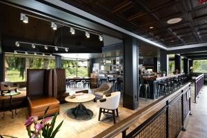 a restaurant with a bar with tables and chairs at Olympia Hotel at Capitol Lake in Olympia