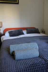 賈科沃的住宿－Studio apartman Hinko，一张带两张蓝色床单和枕头的床