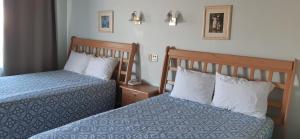 מיטה או מיטות בחדר ב-Hotel Villa Fontana Inn