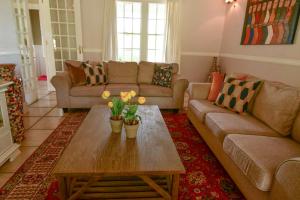 a living room with a couch and a coffee table at Waterford House in Clarens
