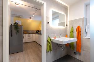 a bathroom with a sink and a kitchen at Haus am See in Hermannsburg +64 photos
