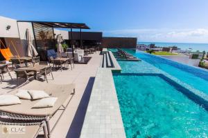 a swimming pool on the roof of a building at Holandas Prime - Flat 722 in João Pessoa