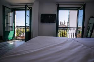 a hotel room with a large window overlooking the ocean at Pombal Rooms Santiago in Santiago de Compostela