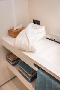 a shelf with towels on it in a bathroom at De Kaleihoeve in Bavikhove