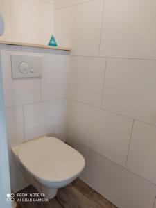 a bathroom with a white toilet and a toilet seat at Au repos des baigneurs, appartement rez-de-chaussée, WIFI in Le Tréport +8 photos