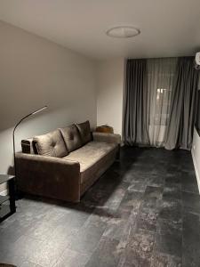 a living room with a couch in the corner of a room at Crystal Apartaments in Kyiv