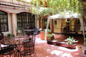 un patio con mesas y sillas y un dosel blanco en Hotel Donaji en Santo Domingo Tehuantepec
