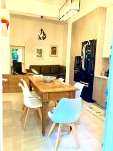 a dining room with a wooden table and white chairs at Casa Buccari in Venice