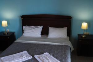 Postel nebo postele na pokoji v ubytování APRAOS BAY HOTEL
