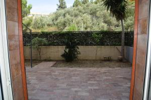 an open door to a courtyard with a fence at Casa di Aida in Messina