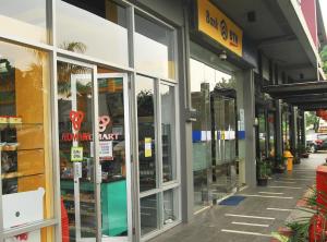 a store front with glass doors on a city street at High Livin Apartment Baros in Cimahi +13 photos