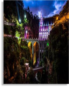 a building on a mountain at night with lights at Hotel Avanty in Ipiales